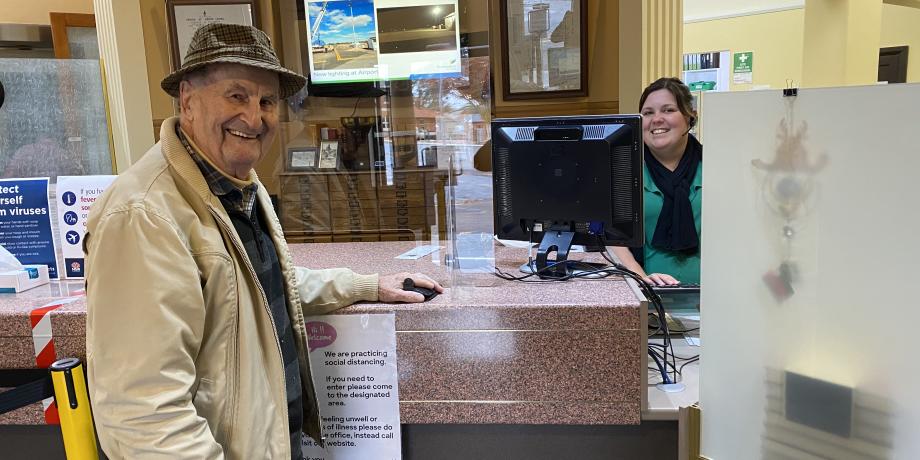 Customer Service Officer Alisha Davies assisting Mr Ken Lean, with perspex and signage in place for everyone’s safety.