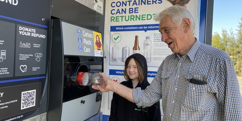 Mayor Kschenka and Harry Kschenka depositing the one millionth item into the Return and Earn Machine