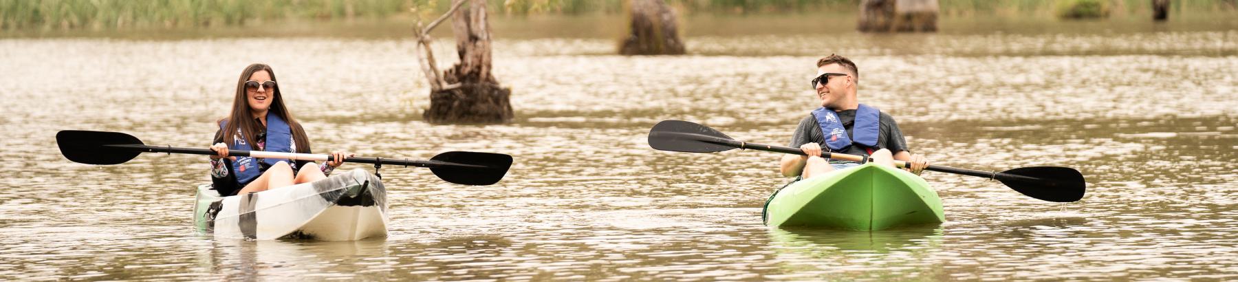 A man and woman canoeing at Rocky Waterholes, Narrandera