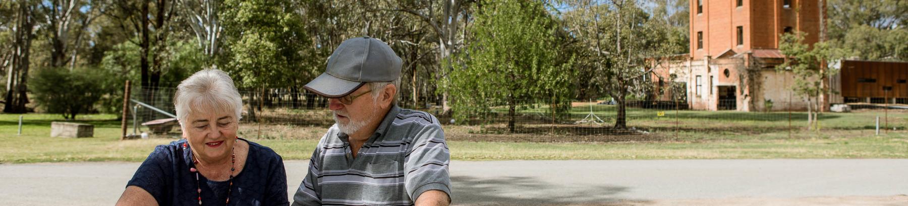 Couple looking at map in front of Oakbank Brewery, Narrandera