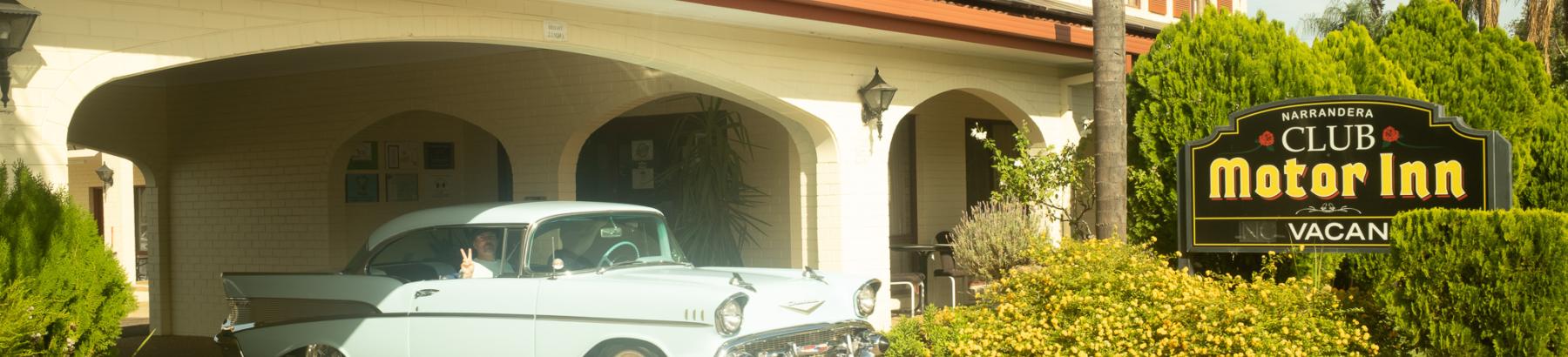 Vintage blue car in entrance to Narrandera Club Motor Inn