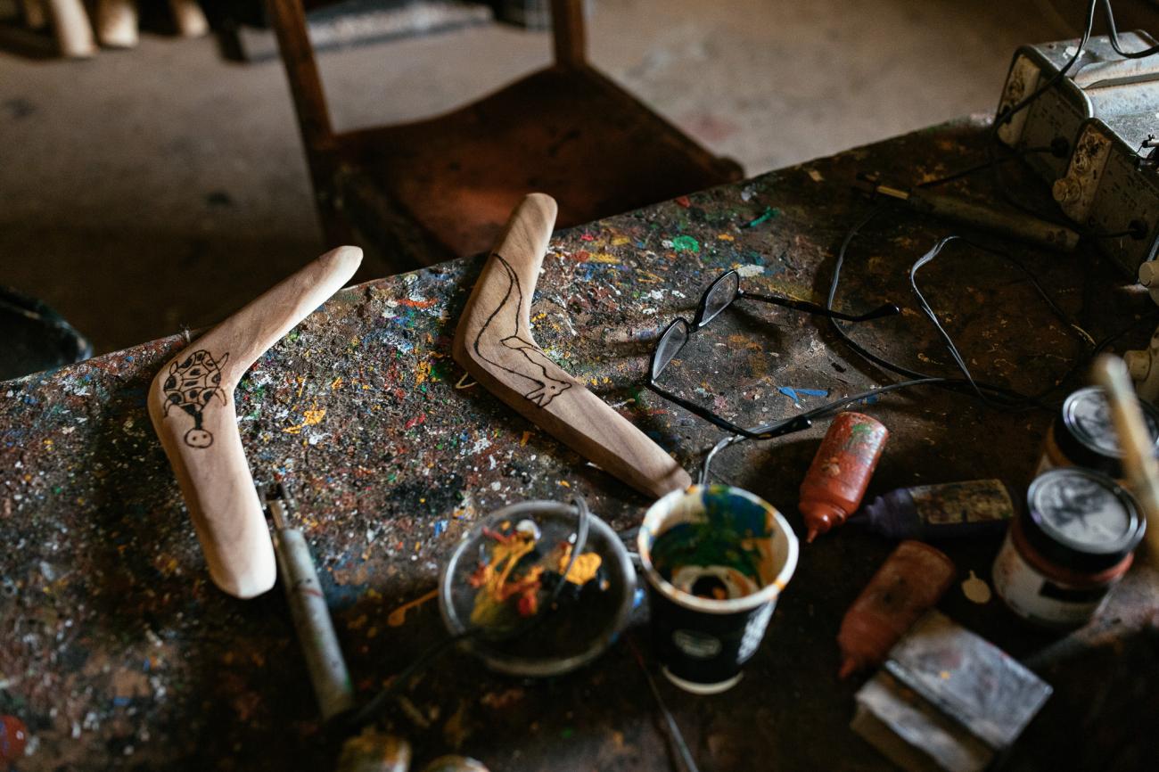 Sandhills Artefacts boomerangs on table to be painted.