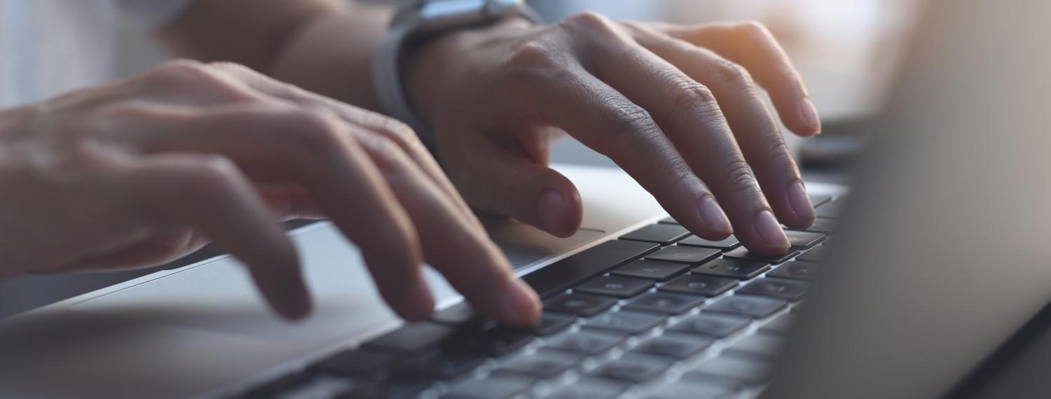 Woman searching for grants on a laptop