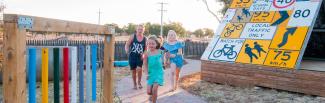 Children running through Grong Grong Earth Park