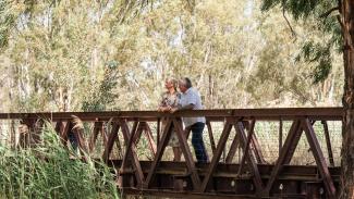 Couple standing on bridge in Narrandera Wetlands