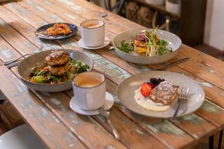 Breakfast served on rustic wooden table at Red Door Cafe