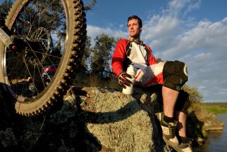 Cyclist resting by Murrumbidgee River