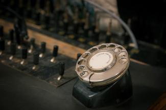 Rotary dial next to black switchboard at the Parkside Cottage Museum, Narrandera. 