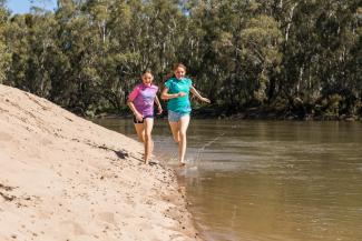 Two girls playing on Second Beach in the Narrandera Flora and Fauna Reserve